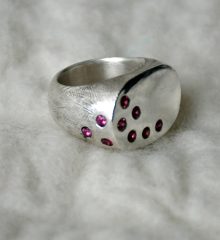 Cast sterling silver ring with nine garnets